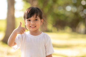 Portrait of cute girl thump up